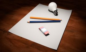 Blank paper, pencil, lightbulb, eraser